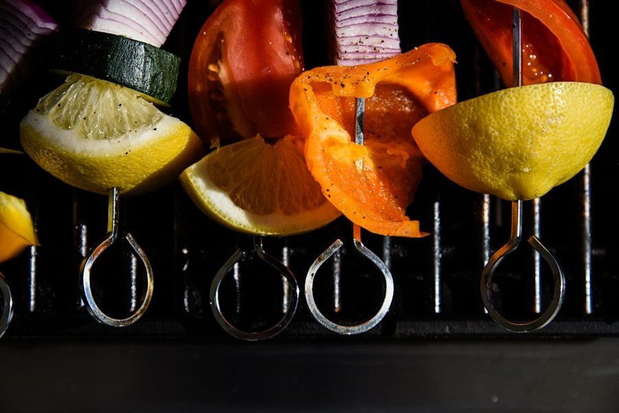 Flaming Kabob Skewers with slices of lemon, zucchini, onion, tomato, orange, and bell pepper on a grill. Commerce TWP, MI