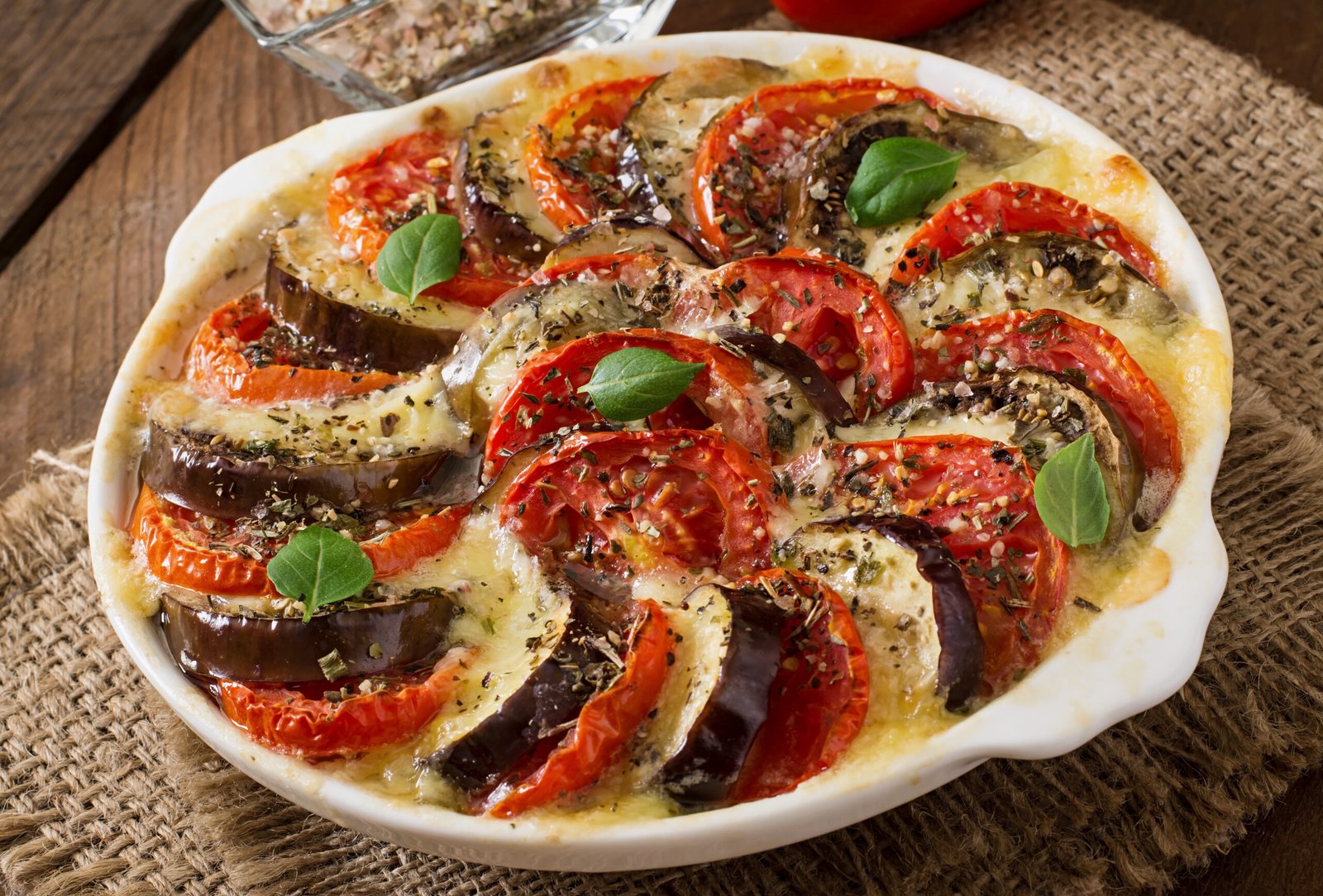 Prepared gratin dish raw eggplant with mozzarella and tomatoes