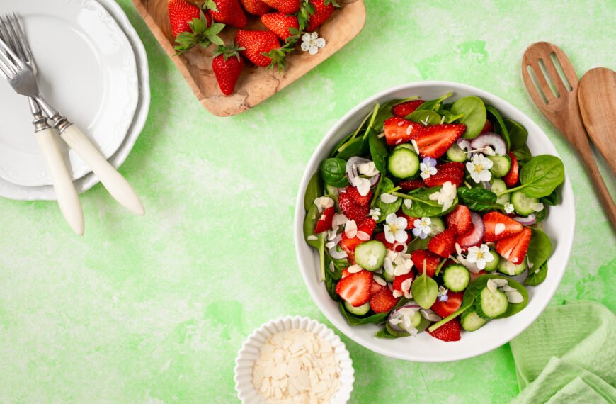Strawberry spinach salad on a green background