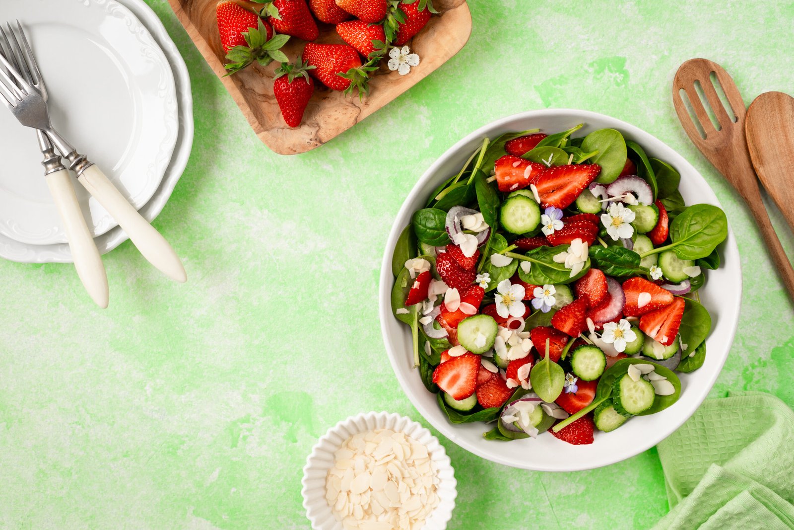 Strawberry spinach salad on a green background