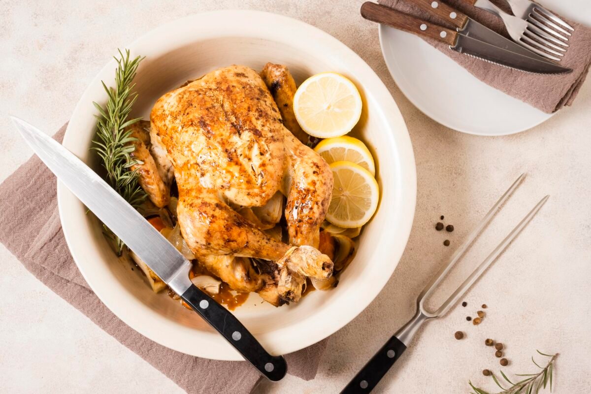 Top view thanksgiving roasted chicken dish with lemon slices